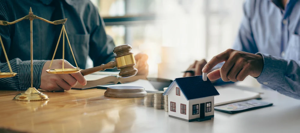 Gavel and residential property representing bankruptcy and litigation disputes
